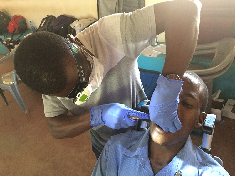 african dentist with patient